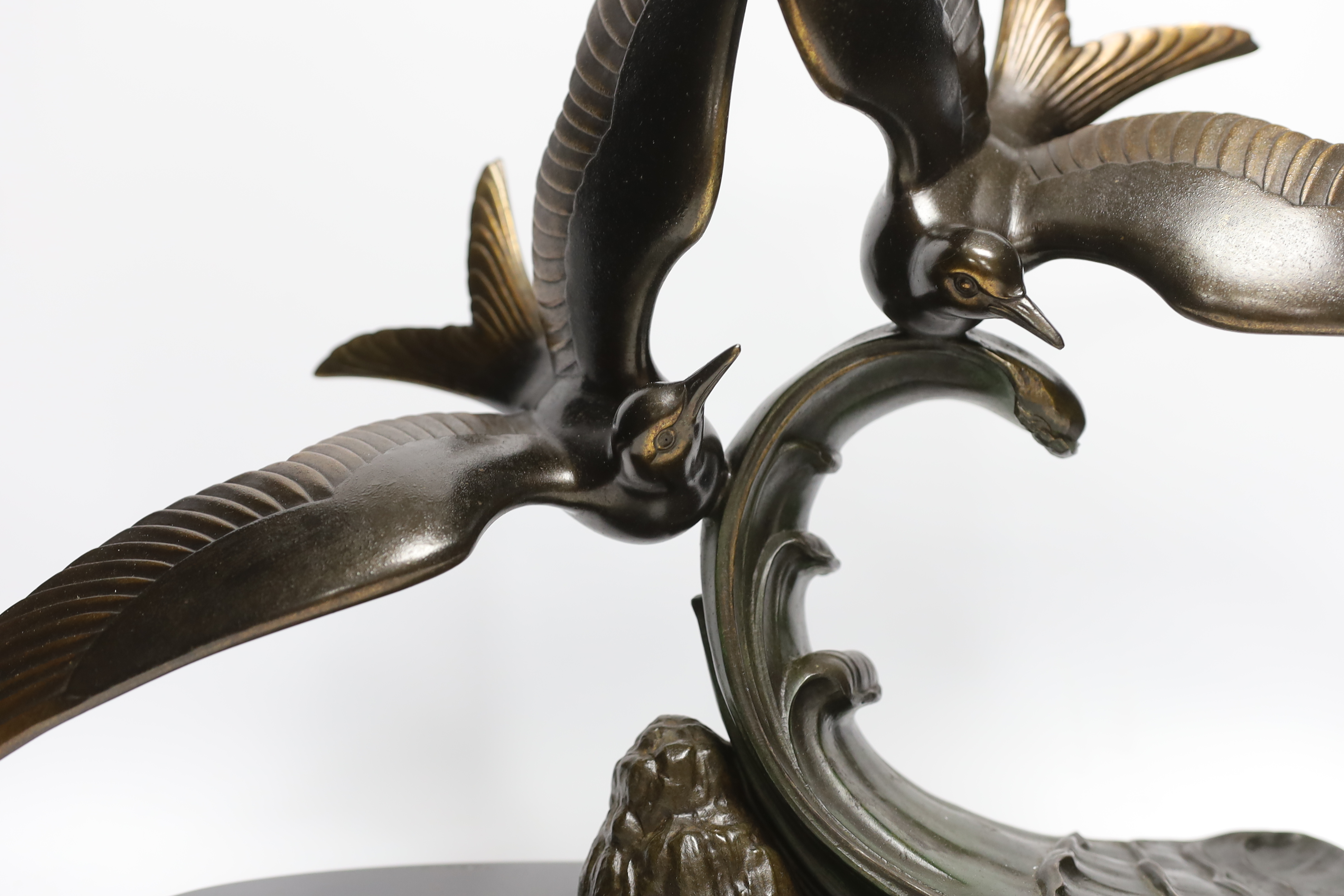 An Art Deco patinated spelter seagull group, signed Trebig, raised on slate base, 48cm wide